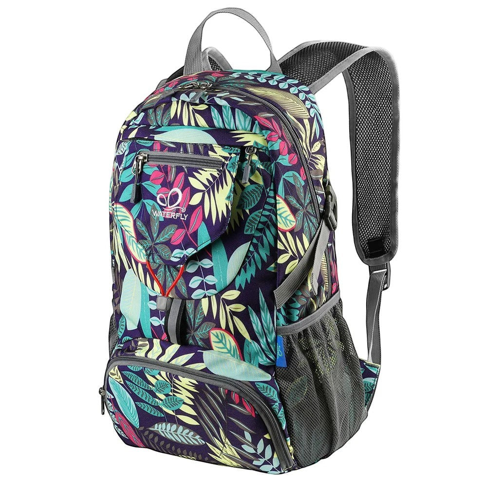 Sac à dos pliable Passion Randonnée 20 L, imprimé feuilles tropicales, bretelles grises et poches latérales en filet.