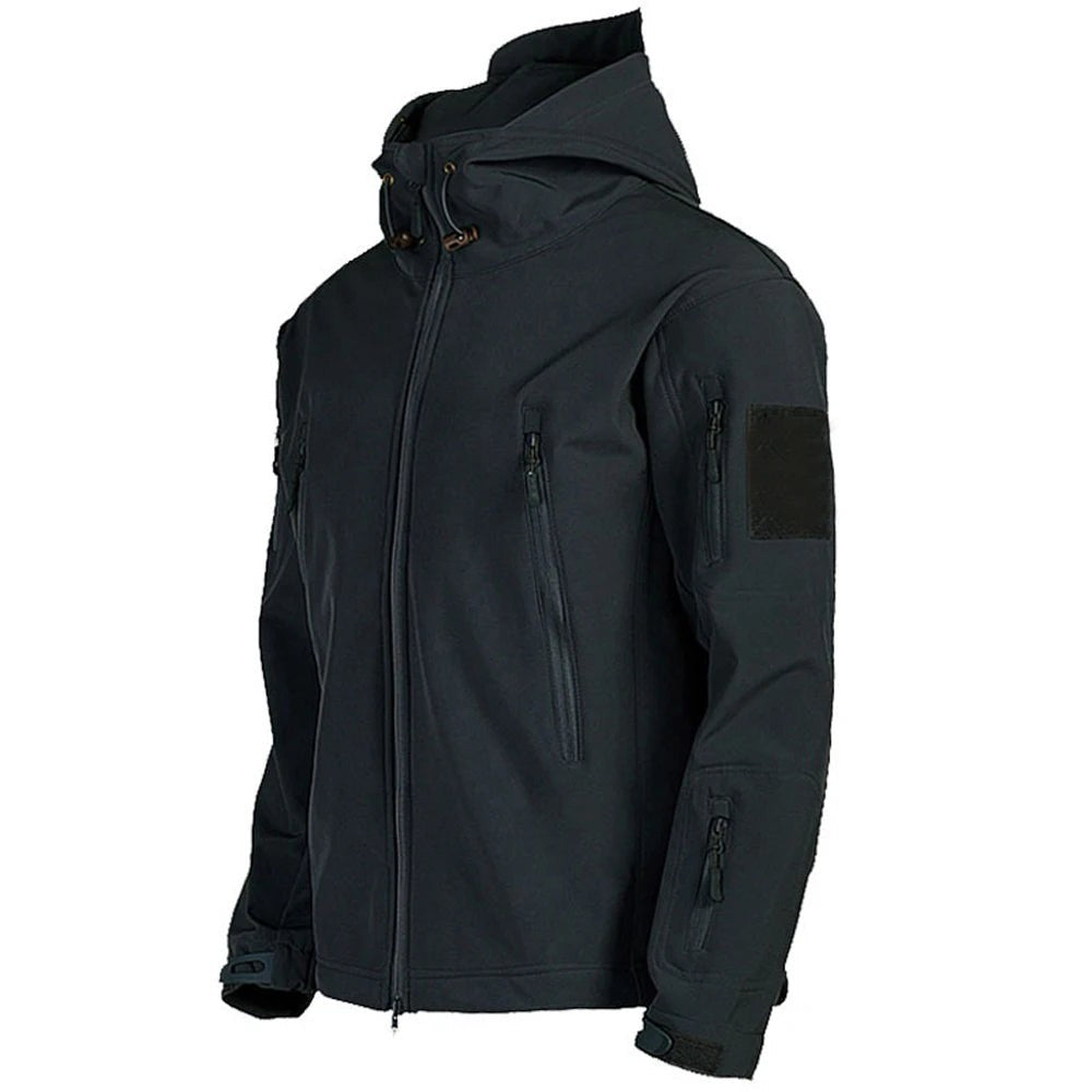 Veste tactique homme noire Passion Randonnée vue de profil, avec capuche, fermeture centrale, poches zippées et patch sur la manche.